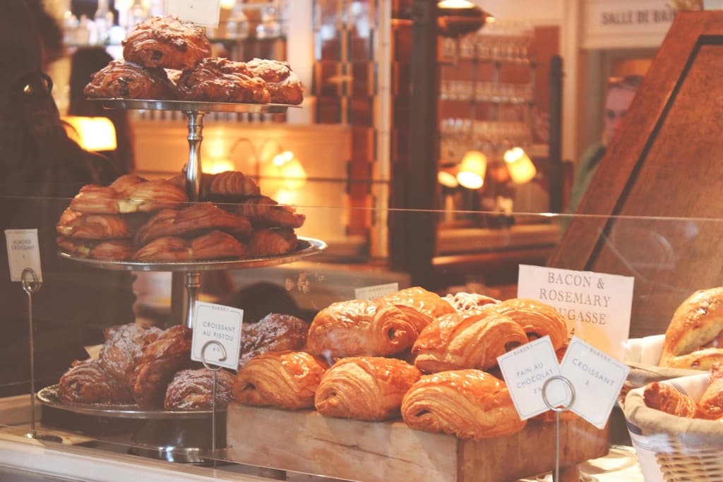 A bakery counter filled with croissants and pastries