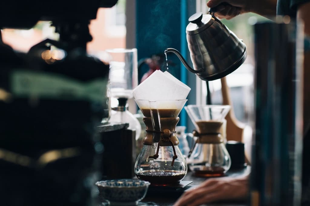 Pour-over coffee brewing at a café counter