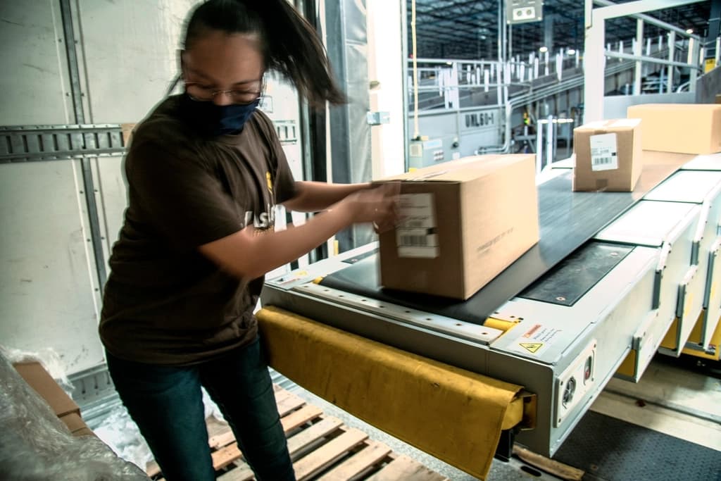 A worker packing a parcel for shipping
