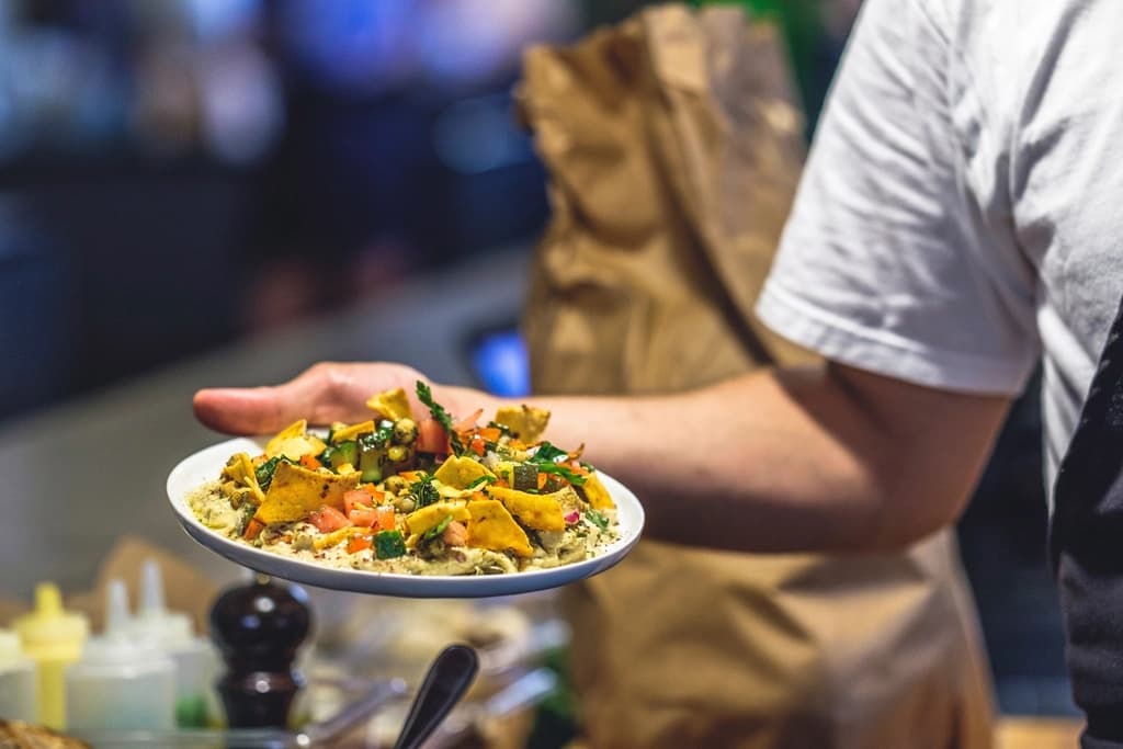A server presenting a plated dish